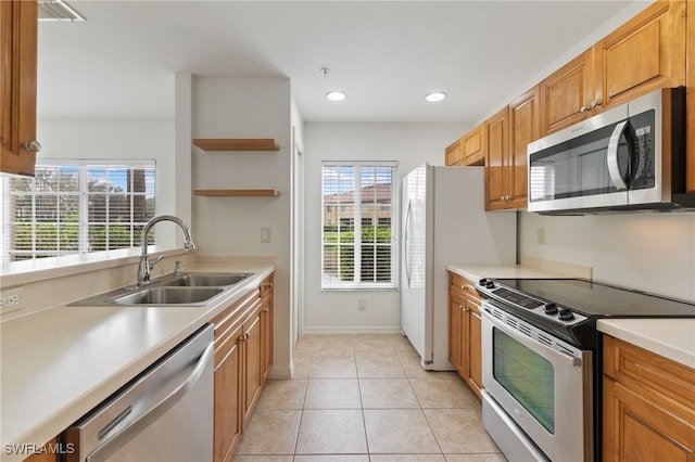 kitchen featuring sink, stainless steel appliances, and light tile patterned floors