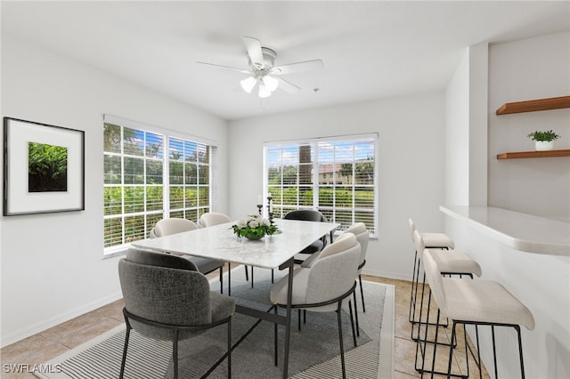 dining space featuring light tile patterned flooring and ceiling fan