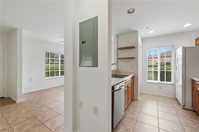 kitchen with electric panel, stainless steel dishwasher, light tile patterned flooring, white fridge, and sink