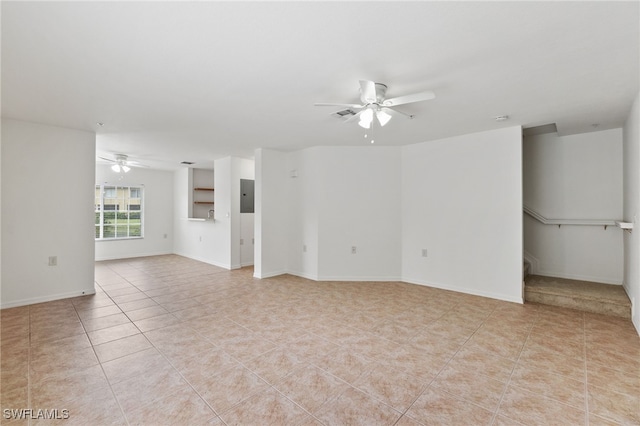 empty room featuring ceiling fan, electric panel, and light tile patterned floors