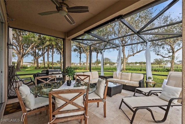 view of patio featuring glass enclosure, ceiling fan, and a grill