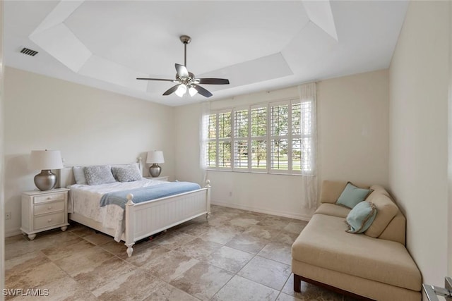 bedroom featuring ceiling fan and a tray ceiling