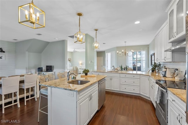 kitchen featuring a breakfast bar area, white cabinetry, sink, and stainless steel appliances