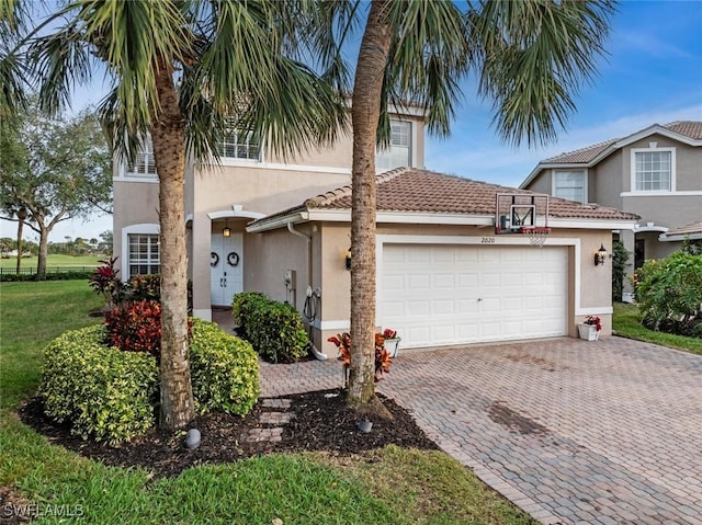 view of front of house with a front yard and a garage