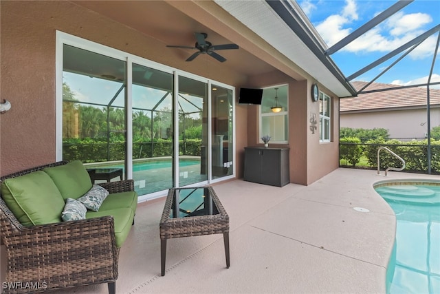 view of patio featuring a lanai, outdoor lounge area, and ceiling fan