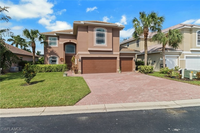 mediterranean / spanish-style house featuring a front lawn and a garage