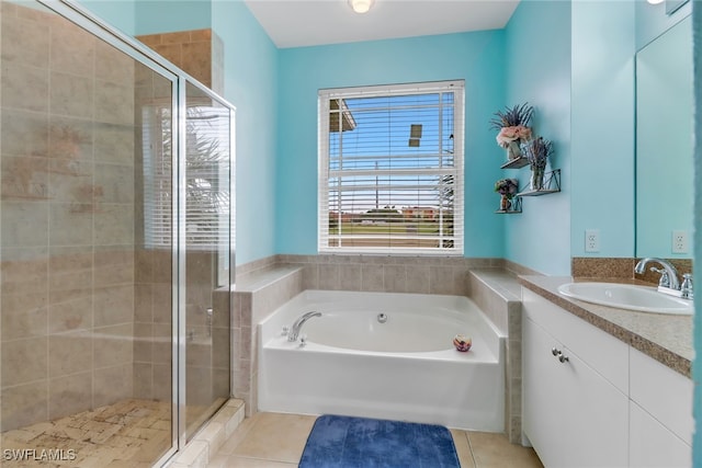 bathroom featuring vanity, shower with separate bathtub, and tile patterned flooring