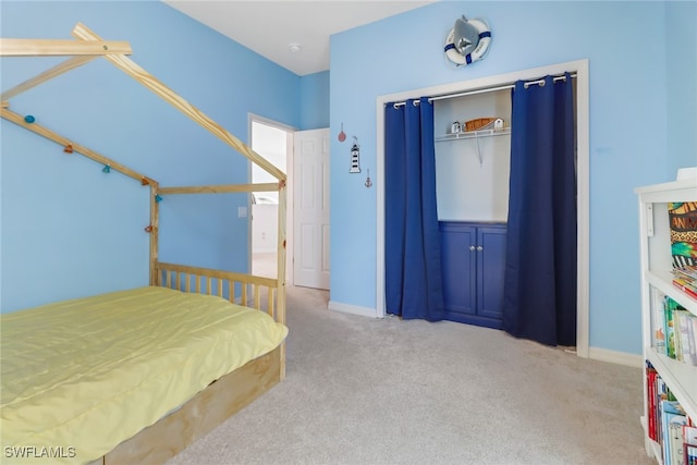 carpeted bedroom with a closet