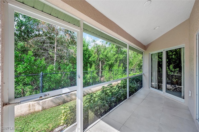 unfurnished sunroom with lofted ceiling