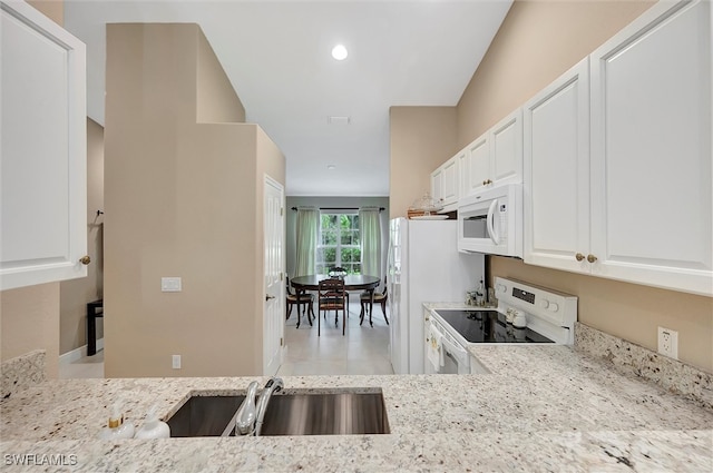 kitchen featuring light stone countertops, sink, white cabinetry, and white appliances