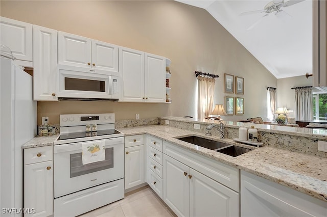 kitchen featuring white appliances, light stone counters, white cabinetry, and sink