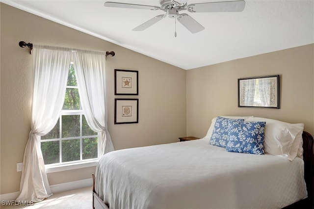 carpeted bedroom with vaulted ceiling and ceiling fan