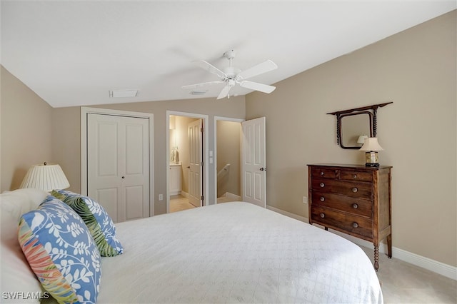 carpeted bedroom with a closet, ceiling fan, connected bathroom, and lofted ceiling