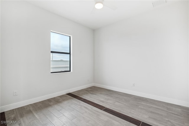 empty room with light wood-type flooring and ceiling fan