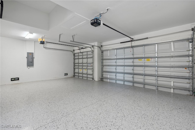 garage with a garage door opener and electric panel