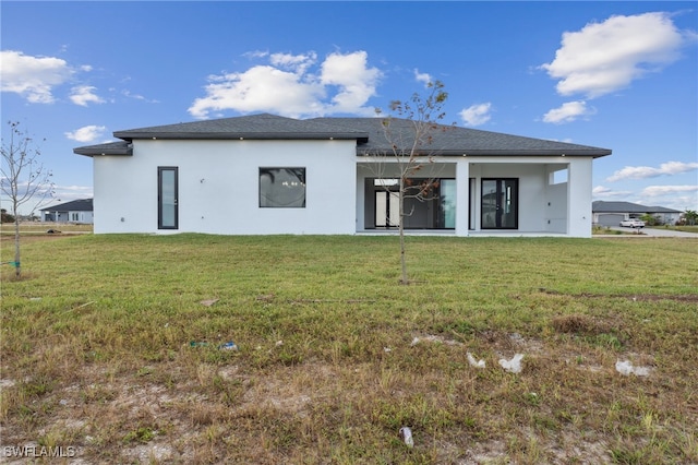 rear view of house with a yard