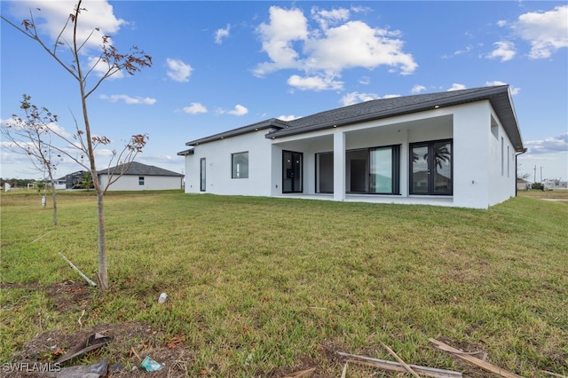 rear view of house with a yard