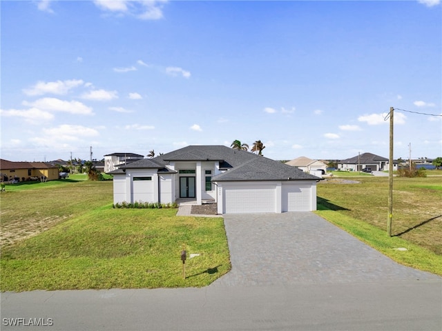 view of front of house featuring a front yard and a garage