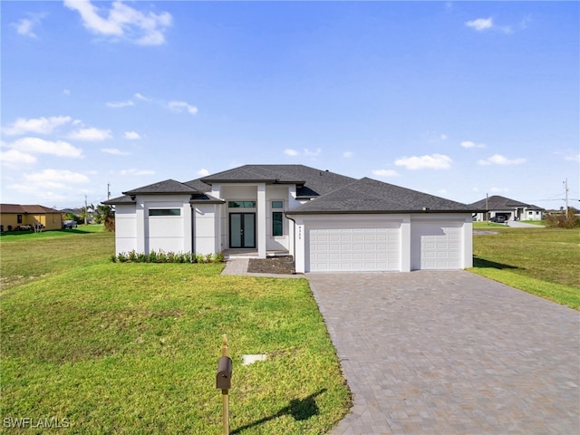 prairie-style house featuring a front lawn and a garage