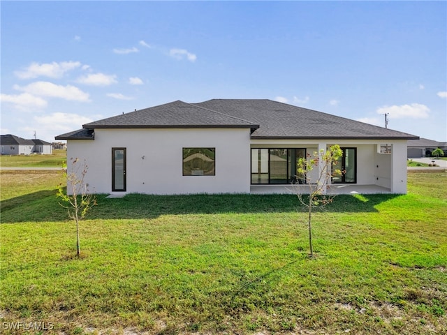 back of house with a patio area and a yard