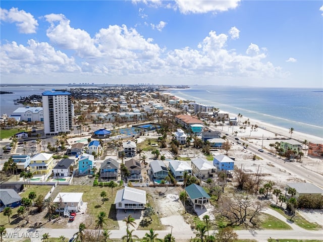 aerial view with a water view and a beach view