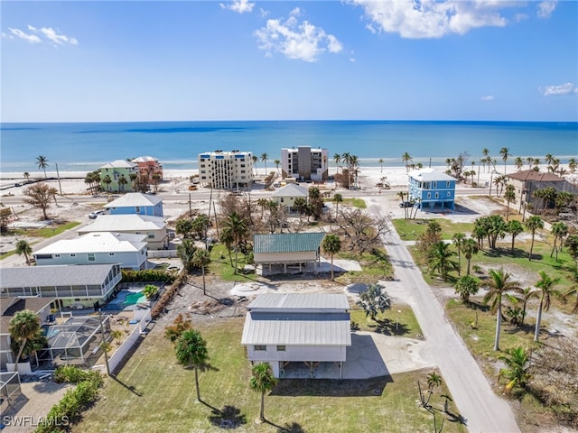 drone / aerial view featuring a water view and a beach view