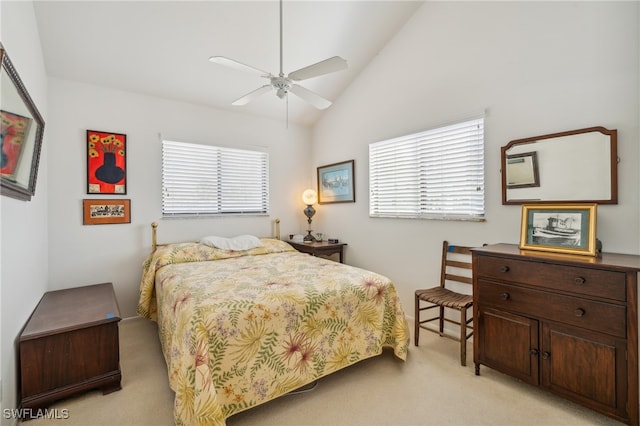 bedroom featuring ceiling fan, high vaulted ceiling, and light colored carpet