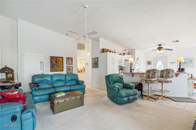 living room with light colored carpet, high vaulted ceiling, and ceiling fan