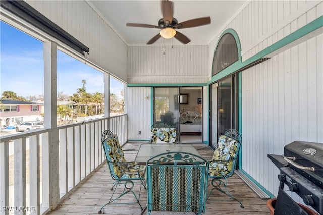 sunroom featuring ceiling fan