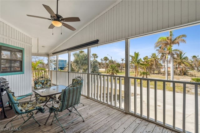 sunroom with ceiling fan and vaulted ceiling