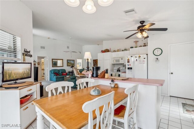 tiled dining area featuring ceiling fan