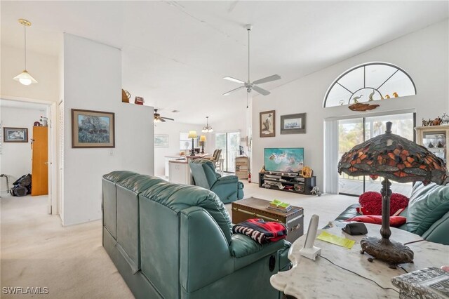 living room with light carpet, high vaulted ceiling, and ceiling fan