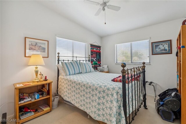 bedroom featuring multiple windows, light colored carpet, and ceiling fan