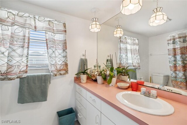 bathroom featuring vanity and toilet