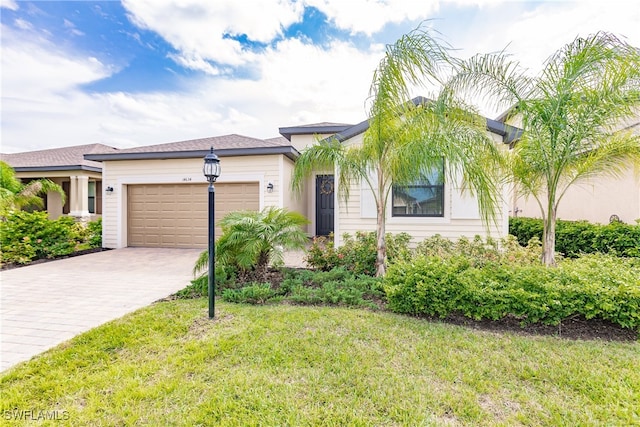 view of front of property with a garage and a front lawn