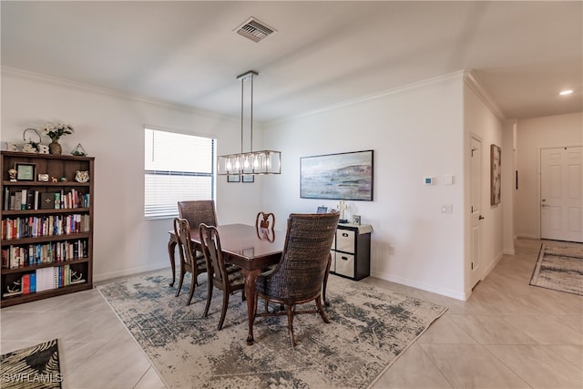 tiled dining area featuring a notable chandelier and ornamental molding