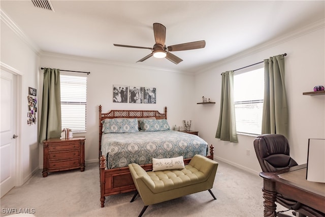 bedroom with crown molding, light colored carpet, and ceiling fan