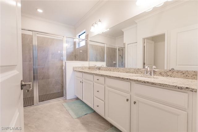 bathroom featuring vanity, crown molding, and an enclosed shower