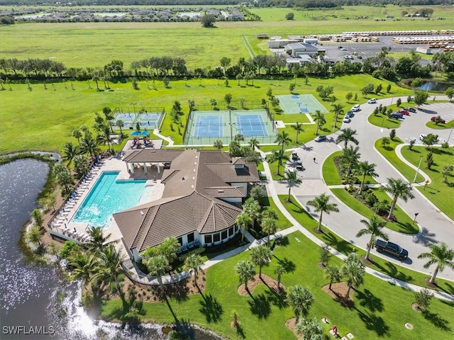 birds eye view of property with a rural view and a water view