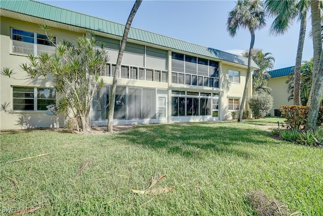 back of house with a lawn