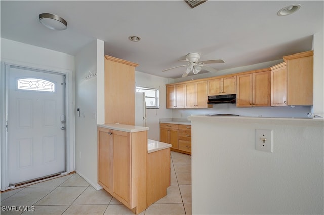 kitchen featuring kitchen peninsula, light brown cabinetry, light tile patterned floors, and ceiling fan