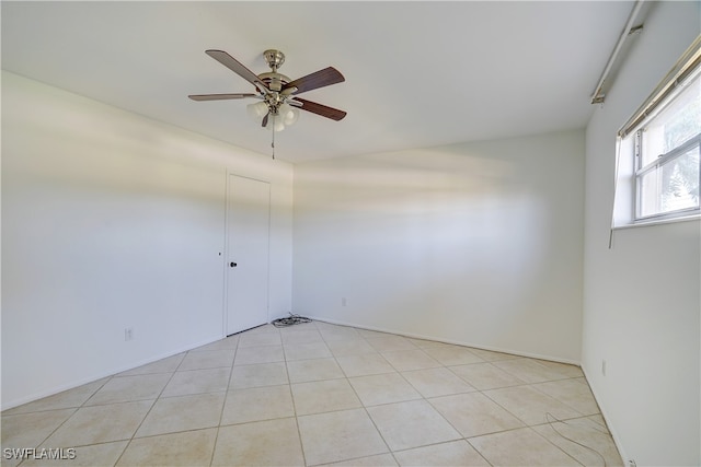 unfurnished room with ceiling fan and light tile patterned flooring