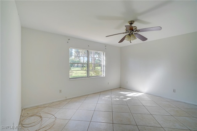 tiled spare room featuring ceiling fan