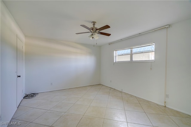 spare room featuring ceiling fan and light tile patterned floors