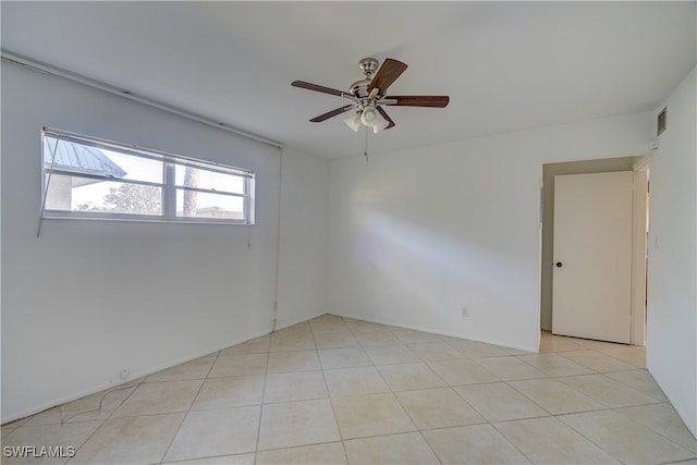 unfurnished room with light tile patterned floors and ceiling fan