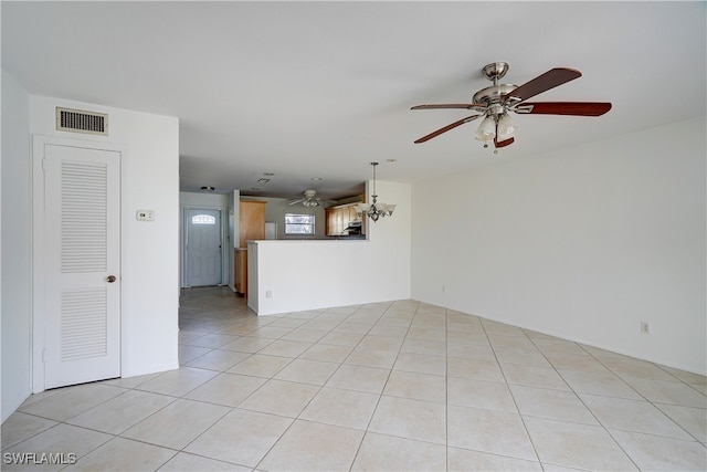 unfurnished living room with light tile patterned floors and an inviting chandelier