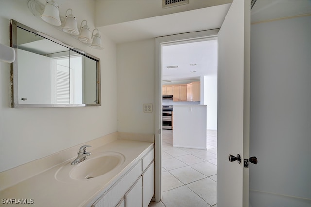 bathroom featuring tile patterned flooring and vanity