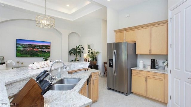 kitchen featuring light stone counters, sink, and appliances with stainless steel finishes