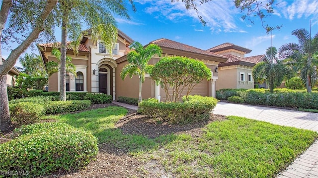 mediterranean / spanish home featuring a front lawn