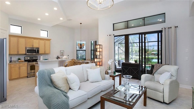 tiled living room with a notable chandelier and a high ceiling